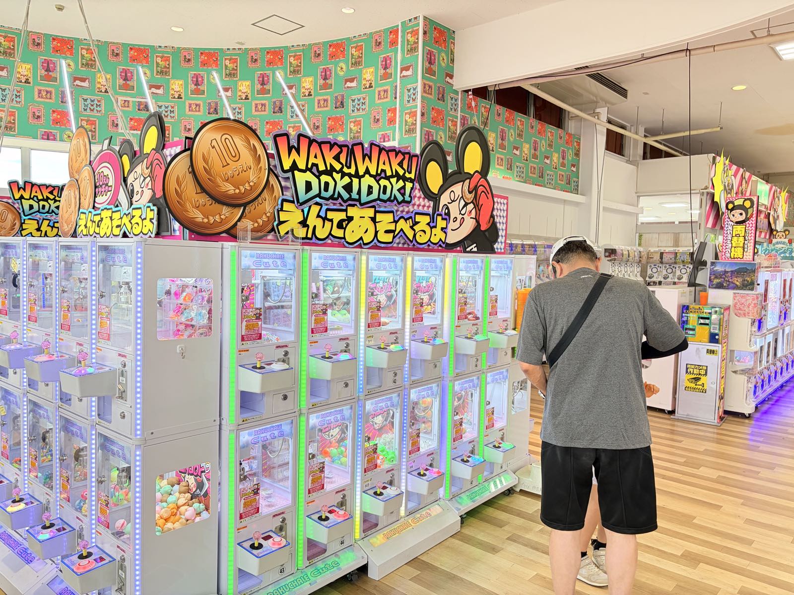 「WAKUWAKU DOKIDOKI えんであそべるよ」の看板と10円硬貨のイラストが掲げられた10円キャッチャーのブース。小型のクレーンゲーム台が上下2段に並んでいる
